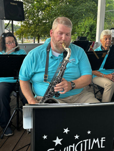 saxophone player performing with band
